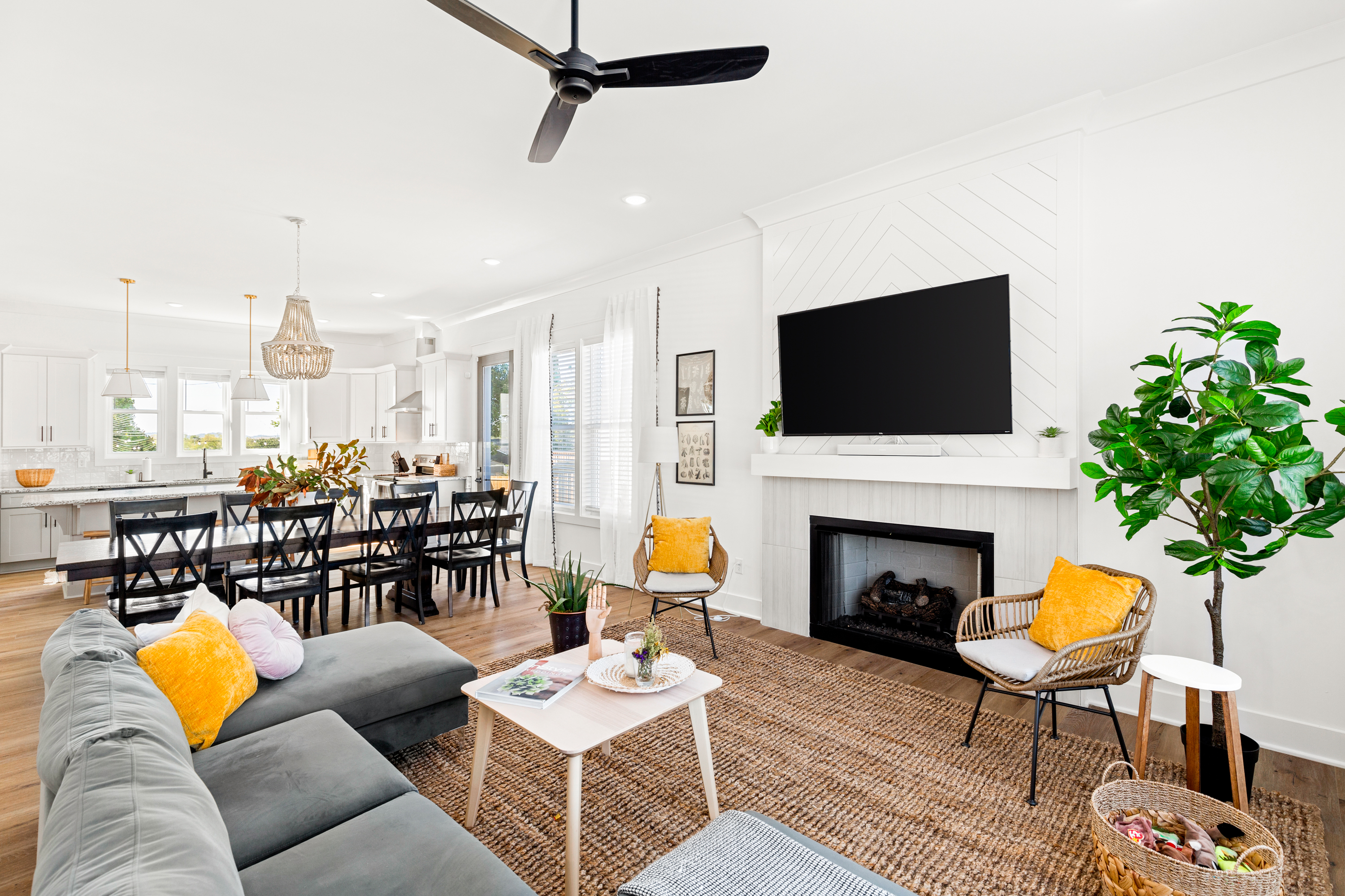 Open-concept living and dining area with cozy seating and fireplace
